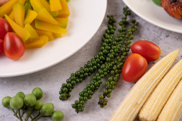 Fresh pepper, baby corn, pumpkin and tomatoes on a white background