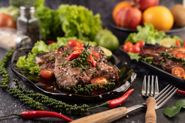 Sliced ​​pork steak topped with white sesame and fresh pepper seeds along.