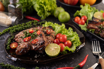 Sliced ​​pork steak topped with white sesame and fresh pepper seeds along.
