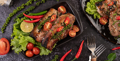 Sliced ​​pork steak topped with white sesame and fresh pepper seeds along.