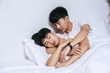Obraz na płótnie Canvas Two beloved young men slept in bed together.