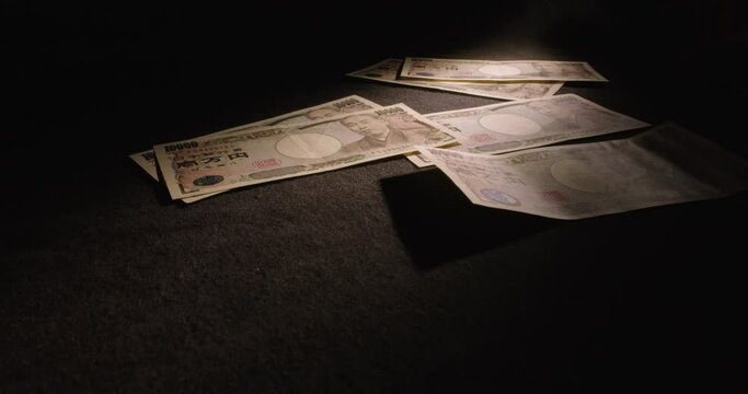Japanese Ten Thousand Yen Bills Being Tossed Onto Table, Low Wide Angle