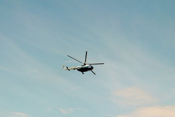 Fototapeta na wymiar Helicopter flight on blue sky background