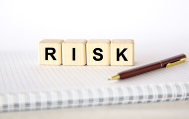 business concept. word RISK on cubes on light background
