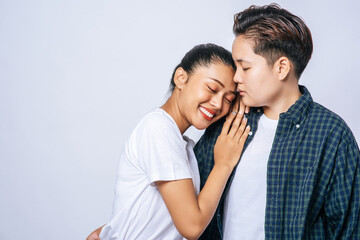 Two dear women stood and held another shoulder.