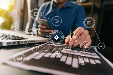 Businesswoman using mobile phone and laptop computer on white desk big data analytics with business intelligence concept. with VR chart and graph with icon
