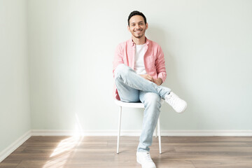 Handsome Latin man sitting in a chair