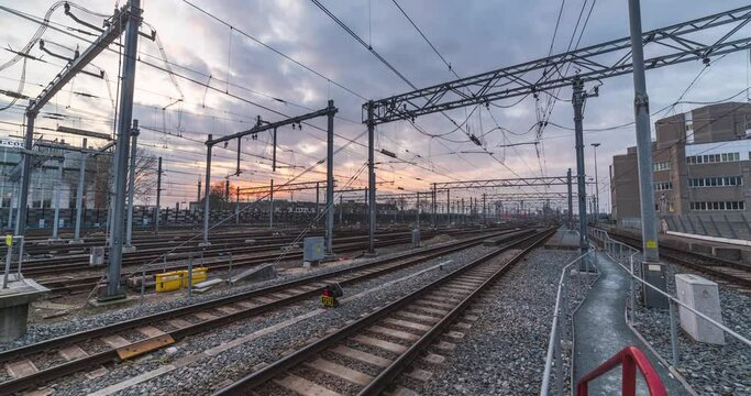 Time lapse of trains riding by and arriving/leaving the trainstation during sunset, Utrecht Centraal, The Netherlands