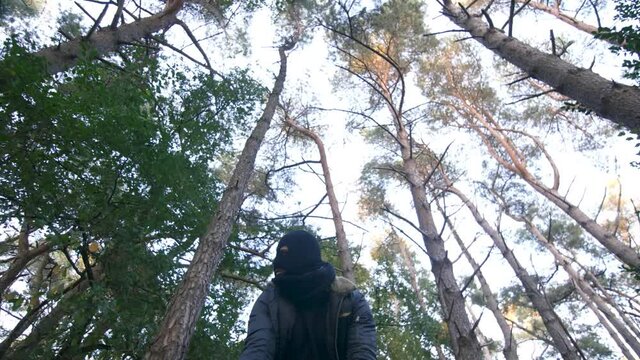 Kidnapper/hit man dragging unconscious body through forest