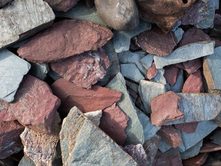 The texture of large stones of various shapes and colors, acute-angled stones