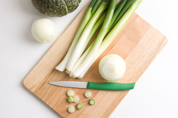 onion and slice of leeks on cutting board