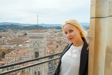 Fototapeta premium Beautiful woman and view of Florence, Italy