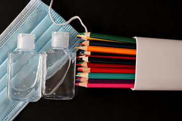 Hand Sanitizer, face masks and colored pencils to go back to school