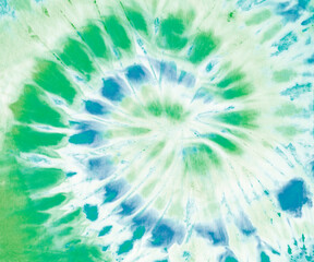 Spiral tie dye pattern in green and blue.  - 376826225