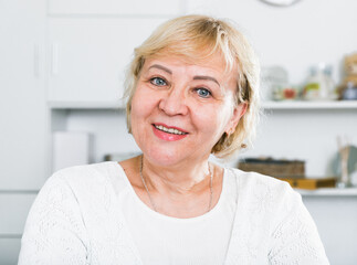 Portrait of a mature confident woman at home at a table