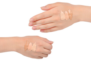 Fair, medium, dark swatches  of foundation on the hand isolated on white.