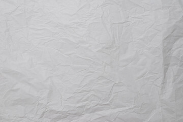 Crumpled white paper background.