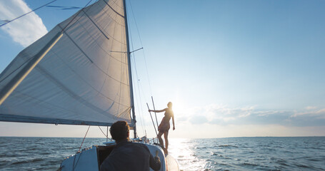 A man and a woman are traveling on a sailing yacht.
