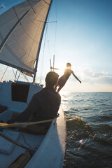 A man and a woman are traveling on a sailing yacht.