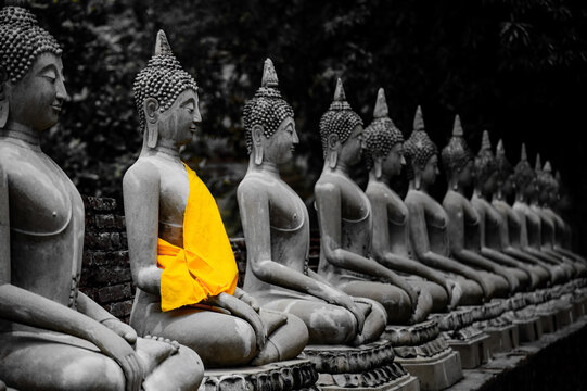 old thai's style of buddha statue in black&white shot with yellow cover flabric