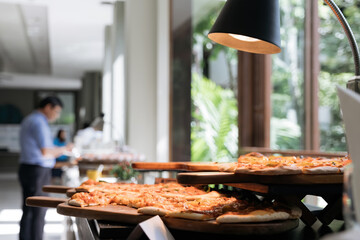 food bar in hot light bulb with people in blurry background, shot with narrow focus.