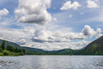 Paul Lake Summer time with green mountains and white clouds british columbia canada.