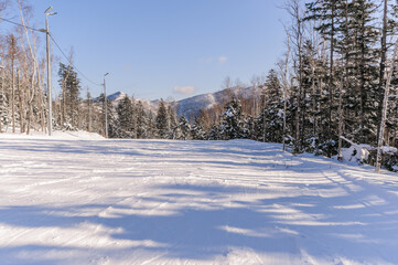 Snow-covered sloping ski slope