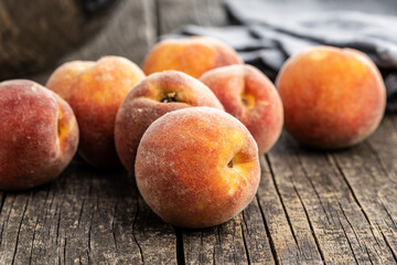 Fototapeta na wymiar Fresh ripe bio peaches on wooden table.