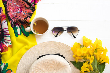 yellow scarf ,sunglasses ,hat and hot tea of lifestyle woman relax summer with yellow flowers...