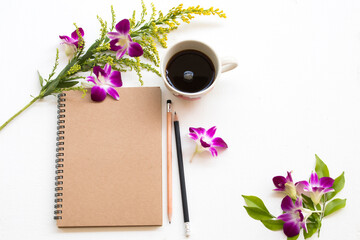 notebook planner for business work with hot coffee espresso ,purple flowers orchid arrangement flat lay style on background white 