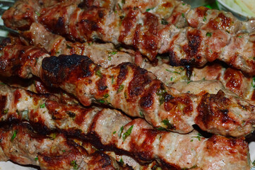 close-up - appetizing tasty shish kebab - marinated pieces of meat fried on skewers