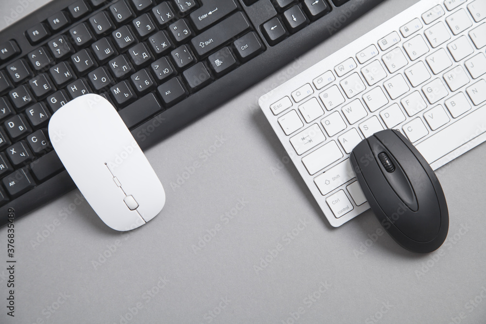 Wall mural computer keyboard and mouse on grey background.