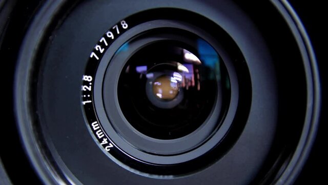 Close up on lens aperture as it opens and closes.