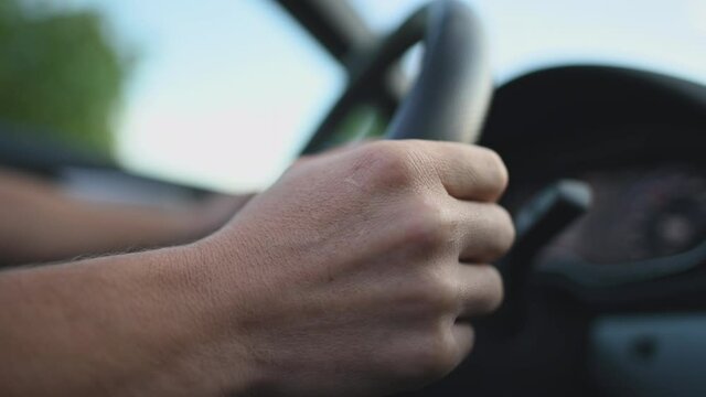 Close Up Of Man Behind Steering Wheel Driving Automatic Car With Manual Mode. Driver Changing Gears By Pressing Manual Shifting Paddles. 