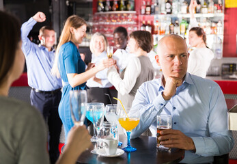 Portrait of sad bored man at corporate party