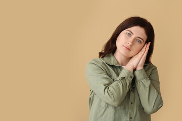 Young deaf mute woman using sign language on color background