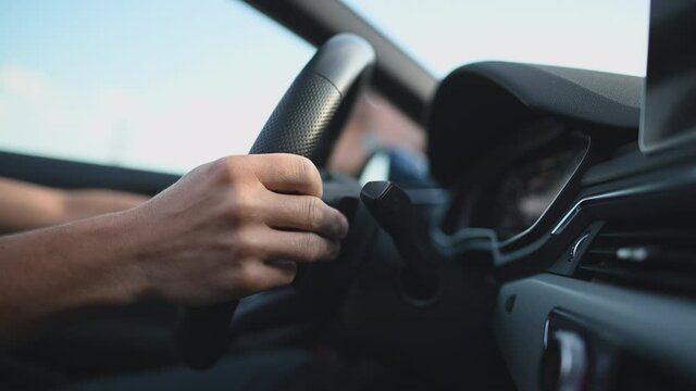 Close Up Of Man Hands Switching Paddles Of Gear Selector On Steering Wheel. Manual Gear Changing Providing More Control Over Driving. 