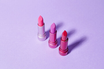 Different lipsticks on color background