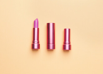 Different lipsticks on color background