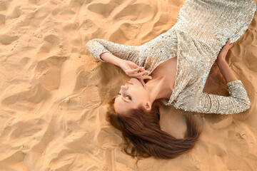 Beautiful fashionable young woman in desert