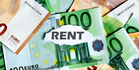 Focus on the word RENT on piece of torn white paper with EUROS currency as a background.
