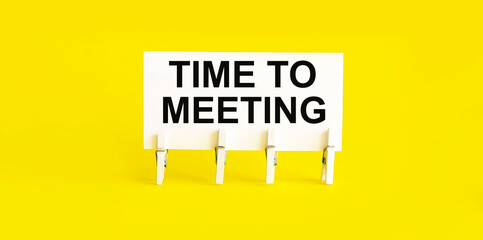 text TIME TO MEETING on white short note paper yellow background