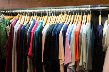 Close up view of stand with various clothes in clothing boutique