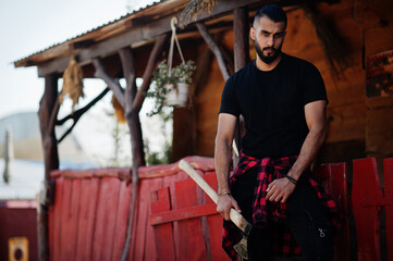 Arab hipster beard man lumberjack hold axe.