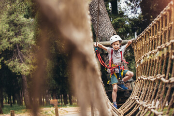 Brave little boy having fun at adventure park