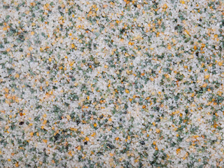 textural plaster of the house wall, colored granite chips, background