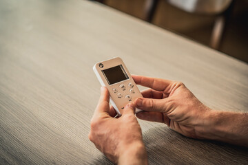 Young man hands hold bio rezonans therapy alternative medicine device, small portable life balance bioresonance for treatment Diseases of the intestinal system