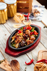 Roasted meat with vegetables in cast iron pan 