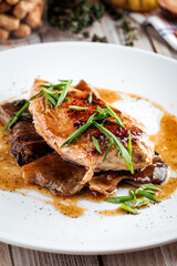 Cooked chicken fillet on mushrooms
