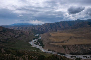 Moutain river valley with sky background. Beautiful wild nature landscape. Adventure travel. Outdoor landscape. Usek river valley in Kazakhstan. Tourism in Kazakhstan concept.